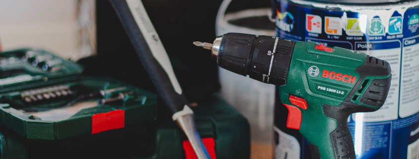 red and black cordless power drill beside black and red cordless power drill